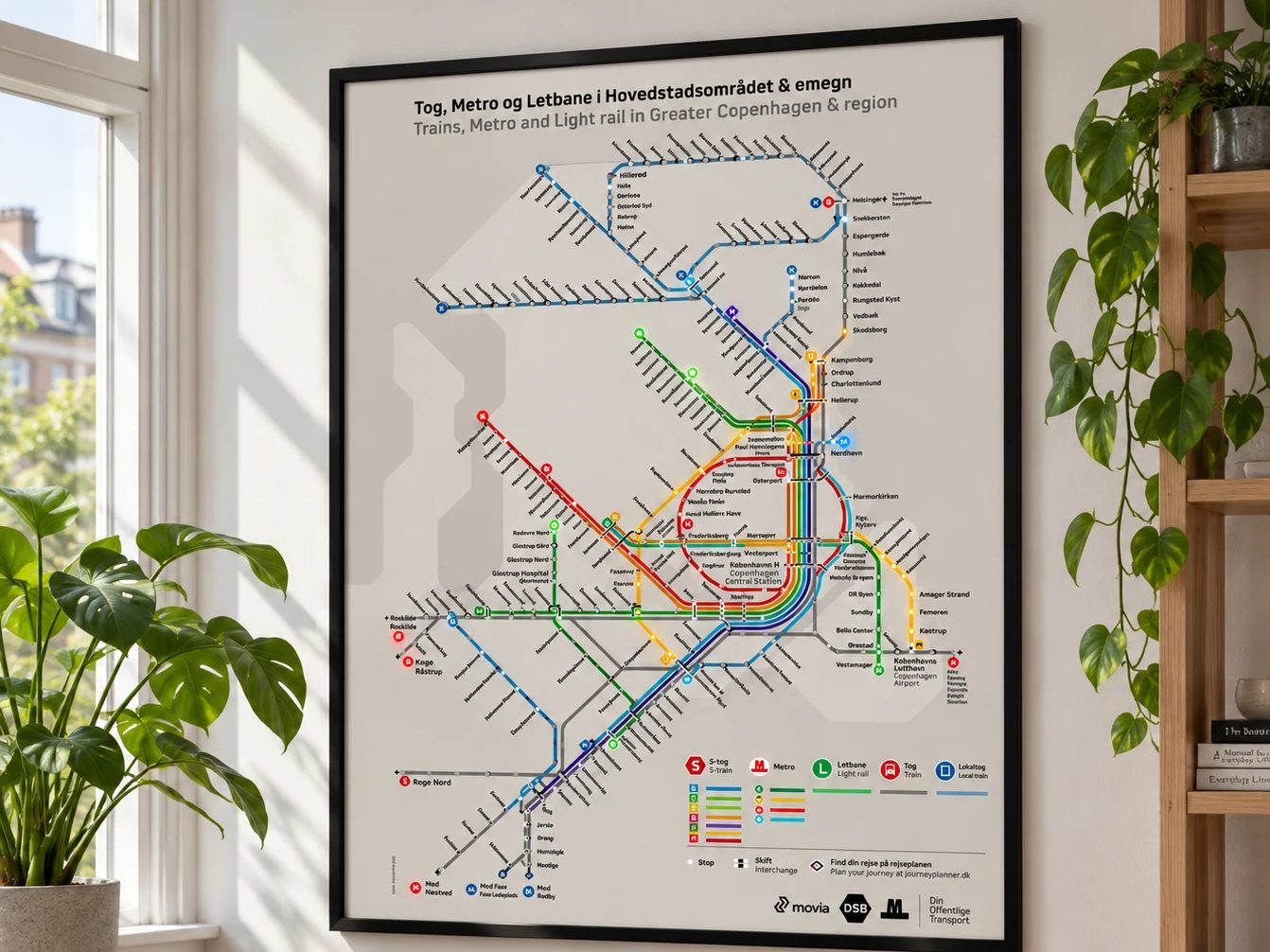 A framed DSB rail network poster on a wall, with selected station LEDs illuminated.